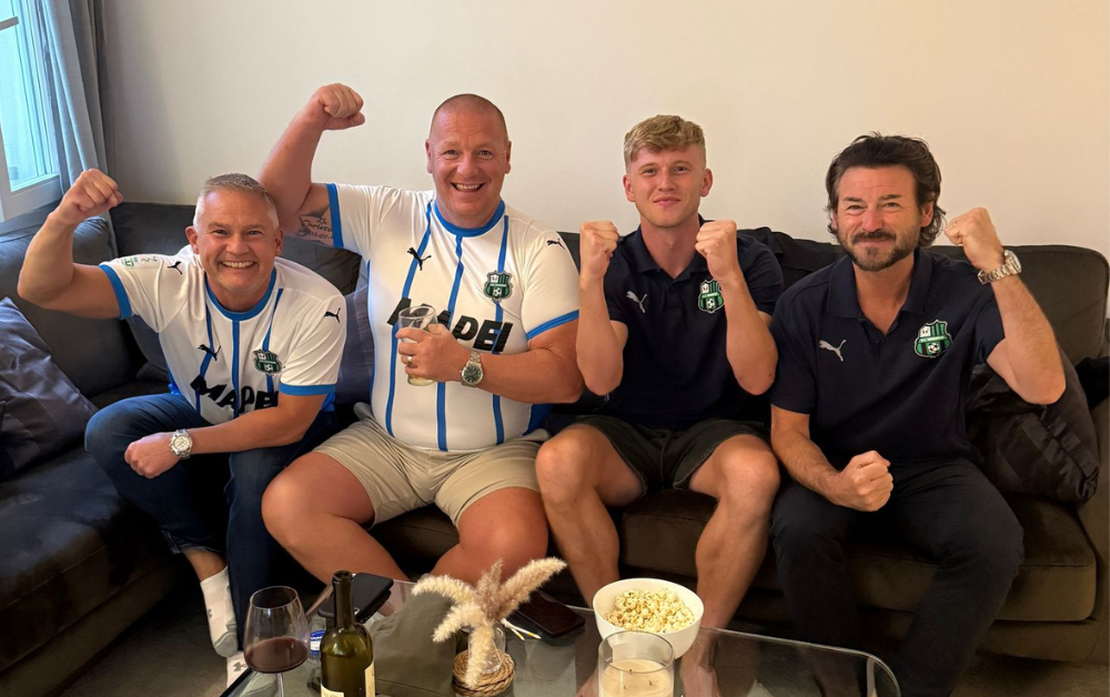 Josh Doig celebrates promotion with his dad and family friends